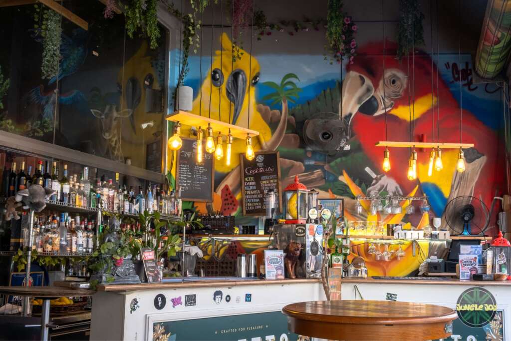 Wildly Stylish Jungle Joy Bar with Captivating Animal Artistic Mural in the Background